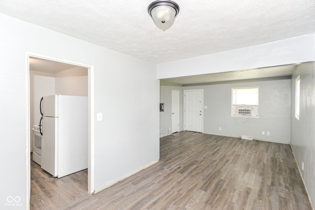 4218 N Irvington Ave, Indianapolis, IN 46226 - unfurnished room featuring wood finished floors, a textured ceiling, and cooling unit