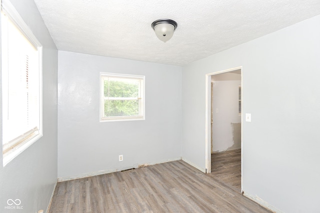 4218 N Irvington Ave, Indianapolis, IN 46226 - spare room featuring wood finished floors and a textured ceiling