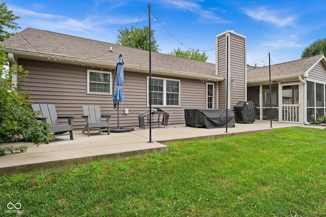 48 Lasalle Ct, Whiteland, IN 46184 - rear view of house featuring a sunroom, a patio, a lawn, a chimney, and roof with shingles