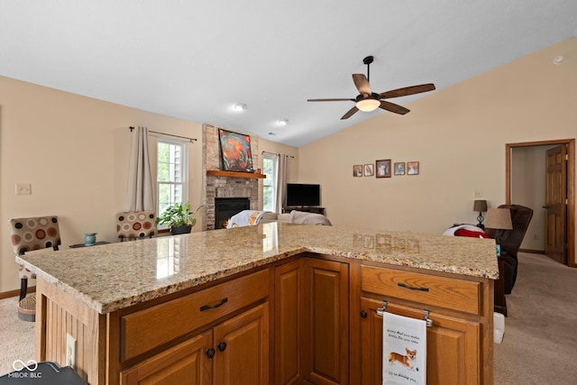 48 Lasalle Ct, Whiteland, IN 46184 - kitchen featuring light carpet, open floor plan, vaulted ceiling, a ceiling fan, and a fireplace