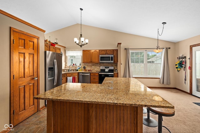 48 Lasalle Ct, Whiteland, IN 46184 - kitchen with appliances with stainless steel finishes, vaulted ceiling, backsplash, a chandelier, and hanging light fixtures
