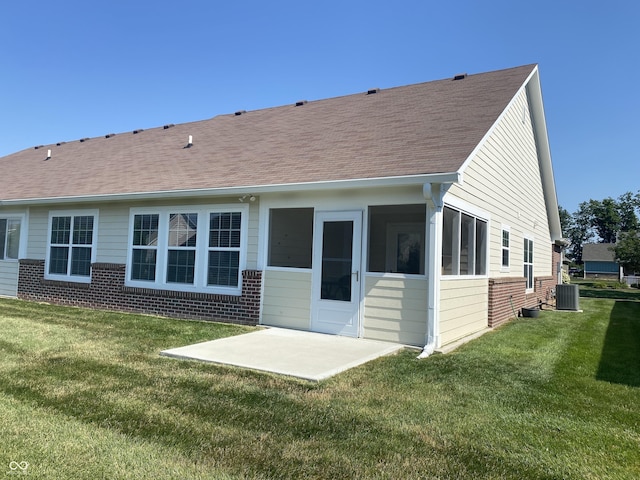 1675 Leisure Way, Greenfield, IN 46140 - back of house with brick siding, a patio, a lawn, roof with shingles, and a sunroom