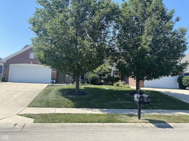 1675 Leisure Way, Greenfield, IN 46140 - obstructed view of property featuring brick siding, a front lawn, an attached garage, and concrete driveway