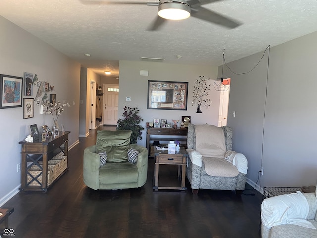 1675 Leisure Way, Greenfield, IN 46140 - living area featuring a ceiling fan, wood finished floors, and a textured ceiling