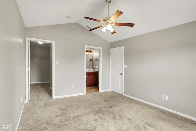 13225 Deception Pass Unit 700, Fishers, IN 46038 - unfurnished bedroom featuring a walk in closet, lofted ceiling, carpet flooring, a closet, and ensuite bathroom
