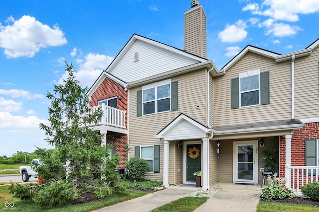 13225 Deception Pass Unit 700, Fishers, IN 46038 - view of property with a chimney and brick siding