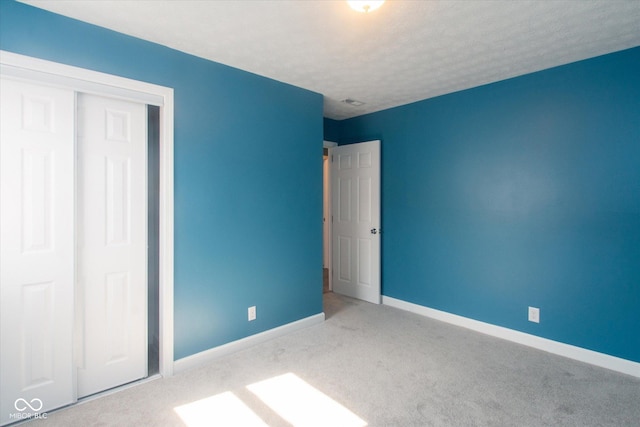 8047 E 48th St, Indianapolis, IN 46226 - unfurnished bedroom with carpet floors, a closet, and a textured ceiling
