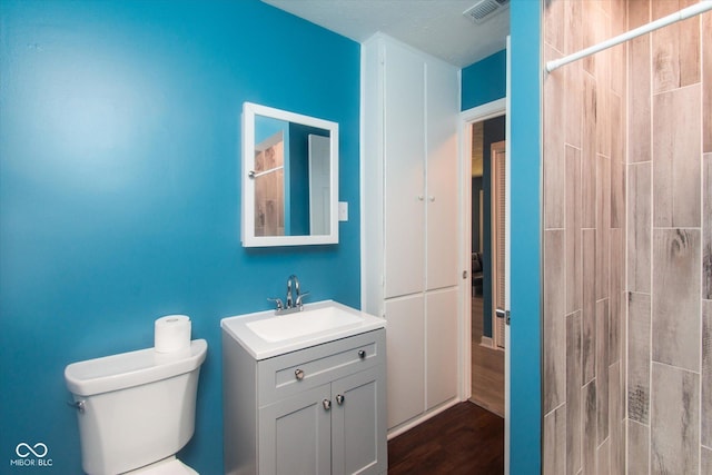 8047 E 48th St, Indianapolis, IN 46226 - full bathroom with vanity, a tile shower, and wood finished floors