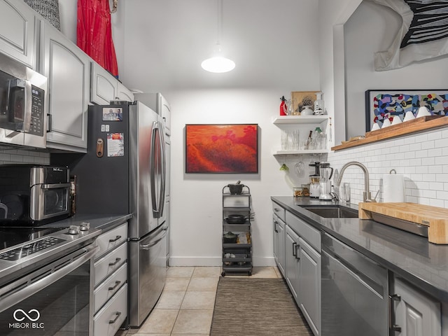 430 N Park Ave Unit 104, Indianapolis, IN 46202 - kitchen featuring dark countertops, tasteful backsplash, and stainless steel appliances