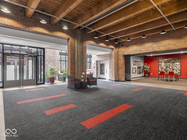 430 N Park Ave Unit 104, Indianapolis, IN 46202 - common area with brick wall, a wood ceiling with exposed beams, and a towering ceiling