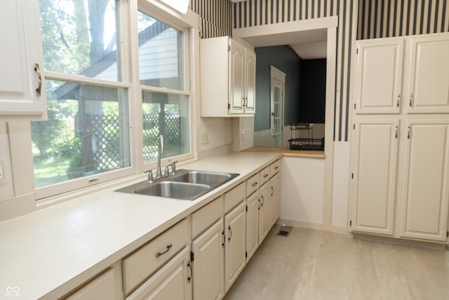 602 Valley Dr, Crawfordsville, IN 47933 - kitchen with healthy amount of natural light, light countertops, and white cabinetry
