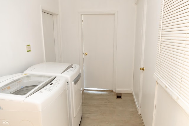 602 Valley Dr, Crawfordsville, IN 47933 - laundry room featuring washer and clothes dryer and light wood-style floors
