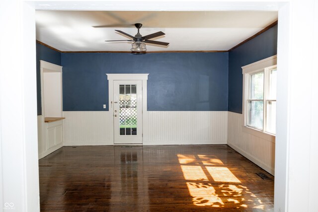 602 Valley Dr, Crawfordsville, IN 47933 - spare room featuring wood finished floors, a wainscoted wall, a ceiling fan, and crown molding