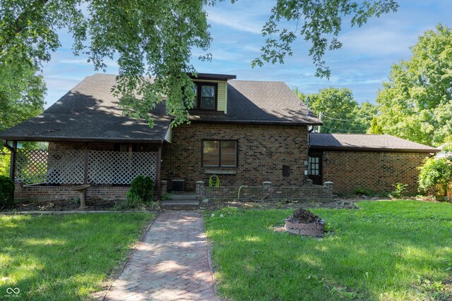 602 Valley Dr, Crawfordsville, IN 47933 - view of front of home with a front yard, brick siding, and a shingled roof