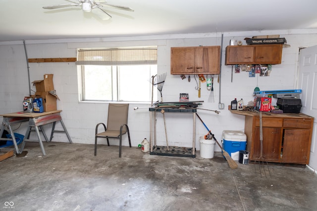 602 Valley Dr, Crawfordsville, IN 47933 - garage with concrete block wall, ceiling fan, and a workshop area