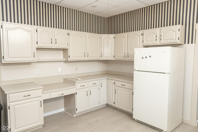 602 Valley Dr, Crawfordsville, IN 47933 - kitchen featuring freestanding refrigerator, wallpapered walls, a paneled ceiling, light wood-type flooring, and open shelves