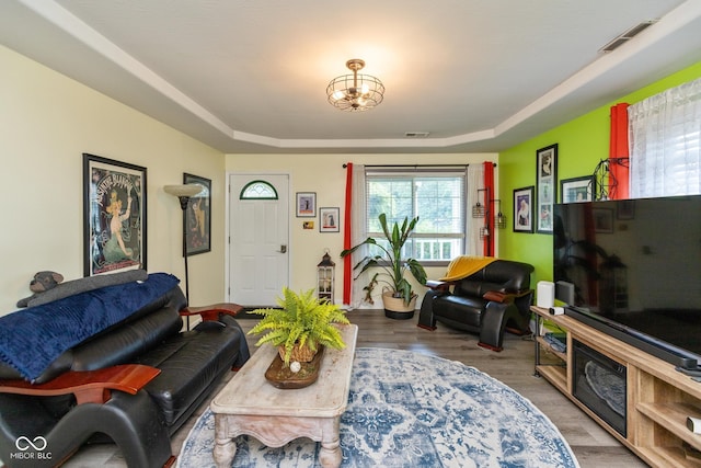 921 Morgan Dr, Indianapolis, IN 46227 - living area with a raised ceiling, wood finished floors, and a chandelier