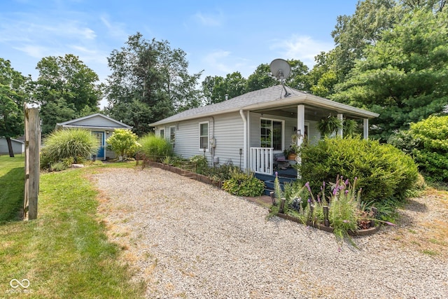 921 Morgan Dr, Indianapolis, IN 46227 - view of front of house with a porch, gravel driveway, and an outdoor structure