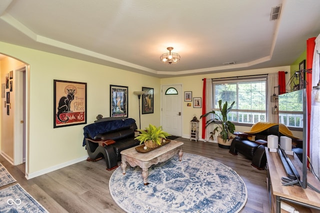 921 Morgan Dr, Indianapolis, IN 46227 - living room with a tray ceiling, arched walkways, and wood finished floors