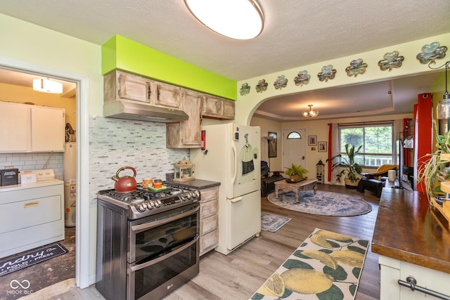 921 Morgan Dr, Indianapolis, IN 46227 - kitchen with range with two ovens, washer / clothes dryer, under cabinet range hood, white fridge with ice dispenser, and arched walkways