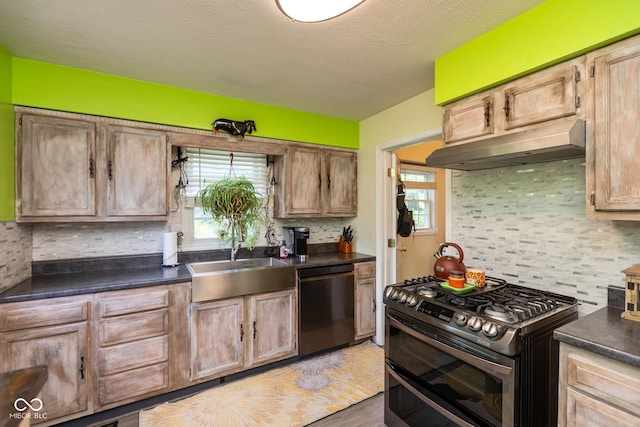 921 Morgan Dr, Indianapolis, IN 46227 - kitchen with appliances with stainless steel finishes, under cabinet range hood, healthy amount of natural light, and dark countertops