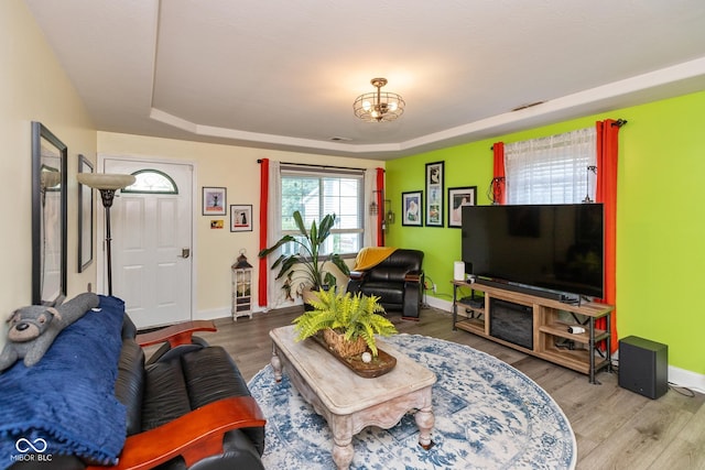 921 Morgan Dr, Indianapolis, IN 46227 - living area featuring a raised ceiling, wood finished floors, and a chandelier