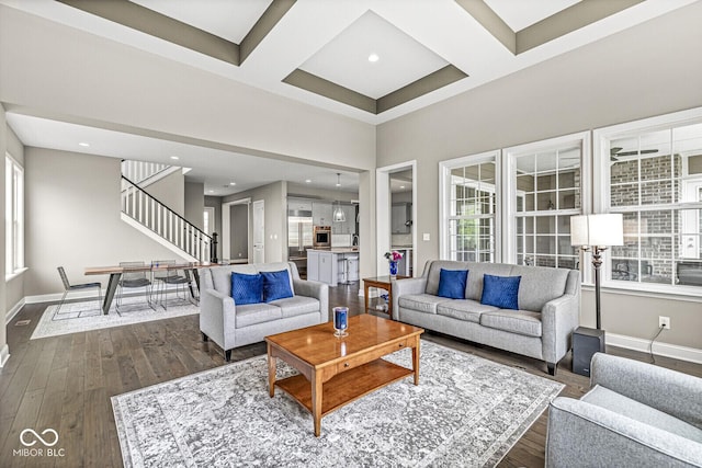 14293 Dufton Ct, Carmel, IN 46074 - living room featuring plenty of natural light, stairway, coffered ceiling, dark wood-style flooring, and beamed ceiling