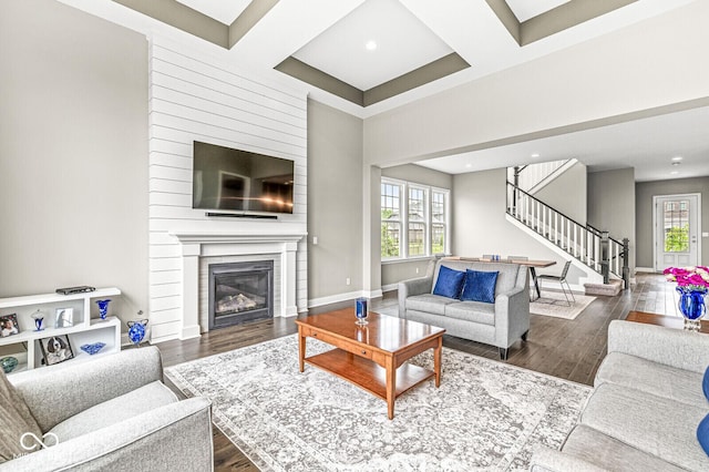 14293 Dufton Ct, Carmel, IN 46074 - living area featuring stairway, coffered ceiling, plenty of natural light, wood finished floors, and a large fireplace