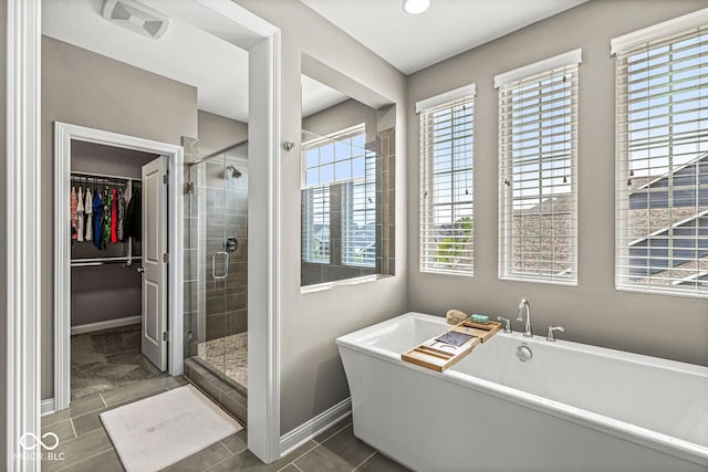 14293 Dufton Ct, Carmel, IN 46074 - full bath featuring a freestanding bath, a spacious closet, a stall shower, and tile patterned floors