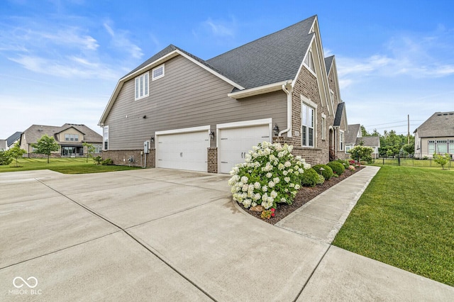 14293 Dufton Ct, Carmel, IN 46074 - view of side of home with brick siding, an attached garage, driveway, a residential view, and roof with shingles
