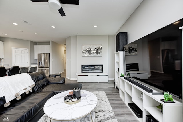 8108 Nik St, Brownsburg, IN 46112 - living area featuring recessed lighting, a ceiling fan, and light wood-type flooring
