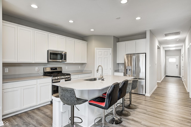 8108 Nik St, Brownsburg, IN 46112 - kitchen featuring stainless steel appliances, light wood-type flooring, recessed lighting, and a kitchen bar