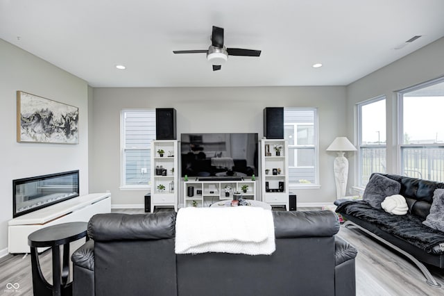 8108 Nik St, Brownsburg, IN 46112 - living room with light wood finished floors, ceiling fan, and recessed lighting
