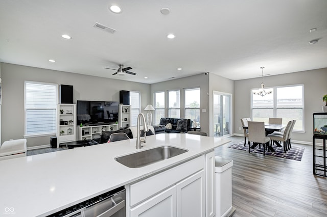 8108 Nik St, Brownsburg, IN 46112 - kitchen featuring light countertops, stainless steel dishwasher, open floor plan, recessed lighting, and white cabinets