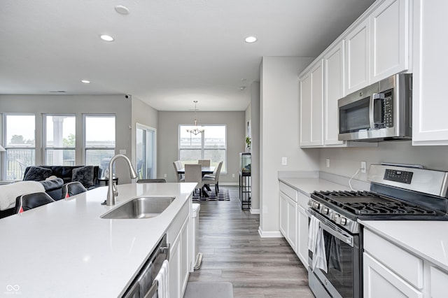 8108 Nik St, Brownsburg, IN 46112 - kitchen with appliances with stainless steel finishes, light countertops, recessed lighting, white cabinets, and open floor plan