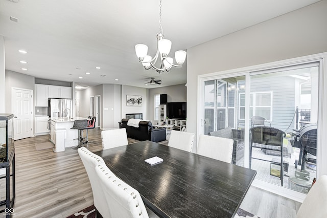 8108 Nik St, Brownsburg, IN 46112 - dining room with a chandelier, ceiling fan, light wood finished floors, and recessed lighting