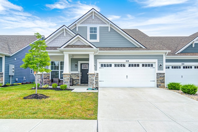 8108 Nik St, Brownsburg, IN 46112 - craftsman-style house with stone siding, a front yard, driveway, a shingled roof, and a porch