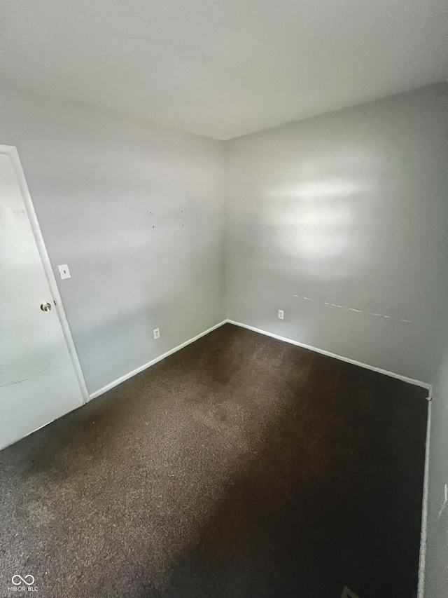 3525 Luewan Ct, Indianapolis, IN 46235 - spare room featuring dark carpet and baseboards