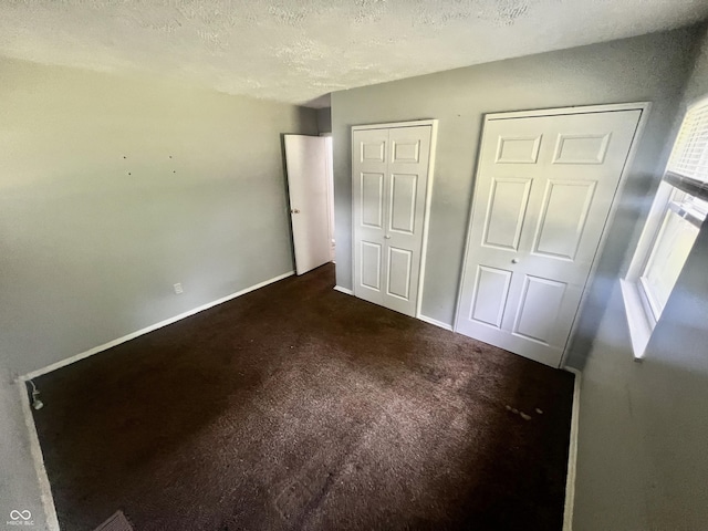 3525 Luewan Ct, Indianapolis, IN 46235 - unfurnished bedroom with carpet flooring, a textured ceiling, and multiple closets