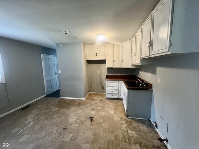 3525 Luewan Ct, Indianapolis, IN 46235 - kitchen with dark countertops and white cabinetry