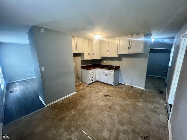 3525 Luewan Ct, Indianapolis, IN 46235 - kitchen featuring white cabinets and dark countertops