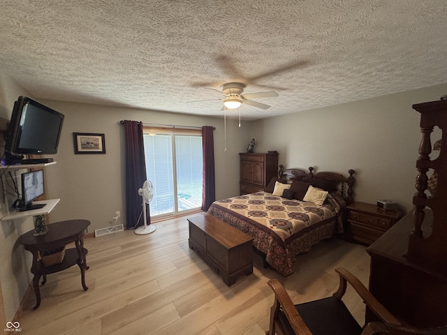 1220 Countryside Ln, Columbus, IN 47201 - bedroom with light wood-type flooring, ceiling fan, a textured ceiling, and access to outside
