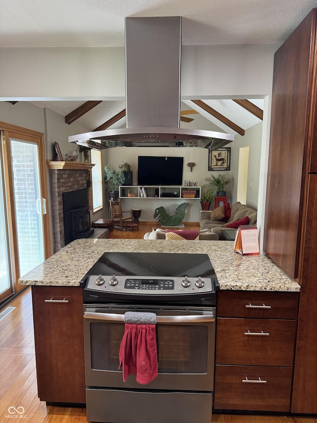 1220 Countryside Ln, Columbus, IN 47201 - kitchen featuring stainless steel range with electric cooktop, open floor plan, ventilation hood, and light stone counters