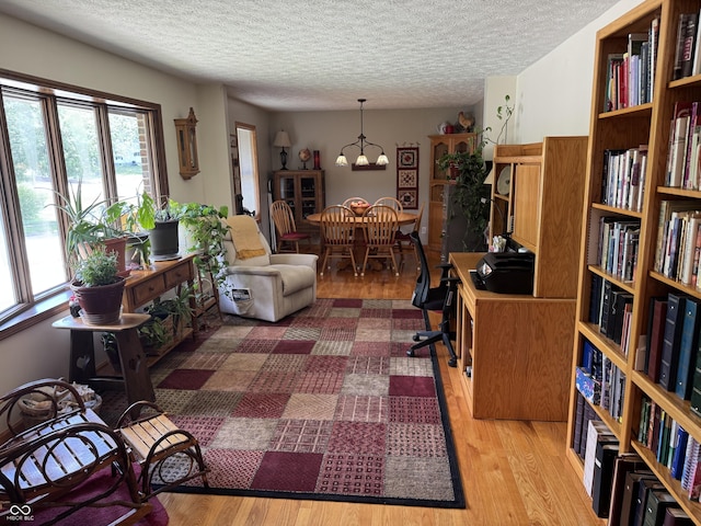 1220 Countryside Ln, Columbus, IN 47201 - office with wood finished floors, a textured ceiling, and a chandelier