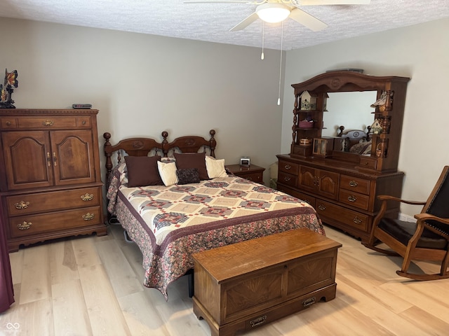 1220 Countryside Ln, Columbus, IN 47201 - bedroom with light wood-style floors, a textured ceiling, and a ceiling fan