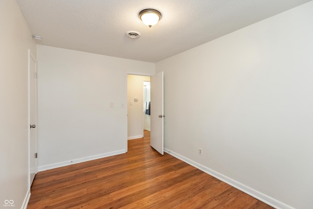 5702 E 17th St, Indianapolis, IN 46218 - empty room featuring light wood-style flooring and a smoke detector
