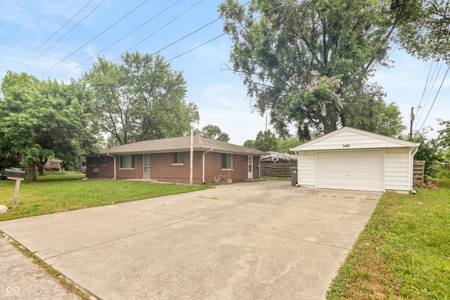 5702 E 17th St, Indianapolis, IN 46218 - view of front of property with a garage, a front lawn, brick siding, an outbuilding, and concrete driveway