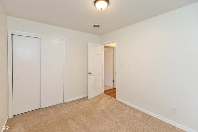 5702 E 17th St, Indianapolis, IN 46218 - unfurnished bedroom featuring carpet flooring and a closet