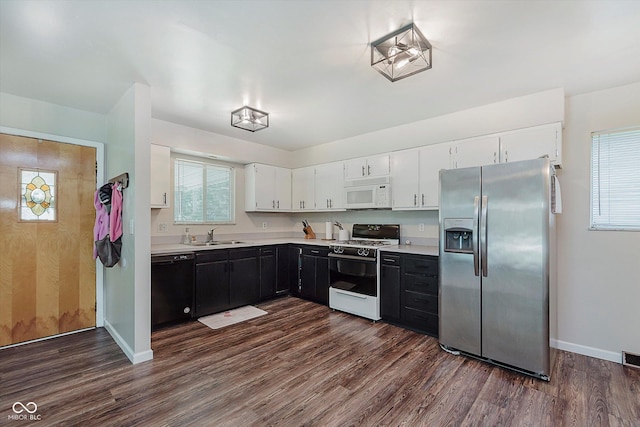 47 Habig Rd, Indianapolis, IN 46217 - kitchen featuring white appliances, light countertops, dark wood finished floors, and white cabinets
