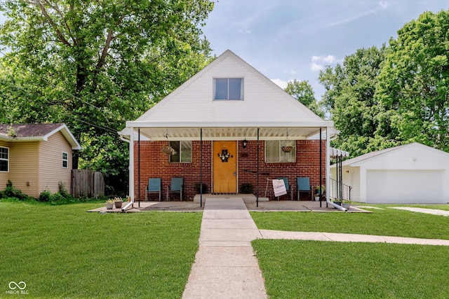 47 Habig Rd, Indianapolis, IN 46217 - bungalow featuring a garage, brick siding, an outbuilding, and covered porch